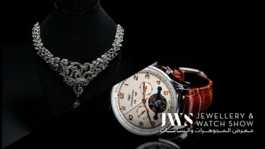A diamond necklace and leather watch collage with a black background 