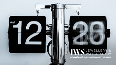 A high-tech silver and black clock showing 12 AM 