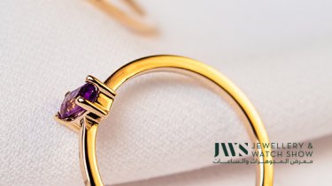gold ring with a violet gemstone