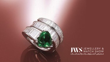 A baguette diamond cut ring embedded with a heart-shaped emerald 