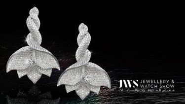 A pair of white gold and diamond earrings shaped like a flower
