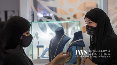 A woman checking out necklaces on display at the Jewellery & Watch Show Abu Dhabi 