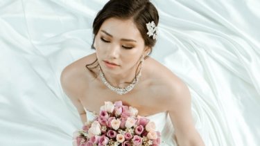 Bride wearing gown with a sweetheart neckline and a choker