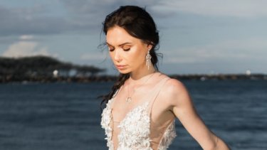 Bride wearing gown with a v-line neckline and a pendant necklace