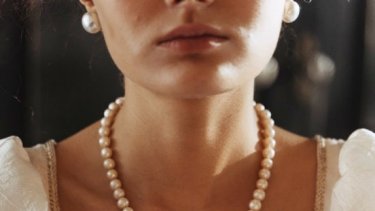 Bride wearing pearl earrings and necklace