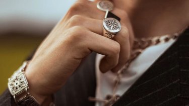 Closeup of man wearing various jewellery