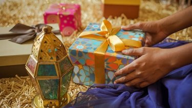feminine hand holding wrapped gift