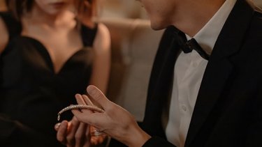 Man presenting diamond jewellery to woman