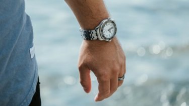 Man wearing silver watch and ring