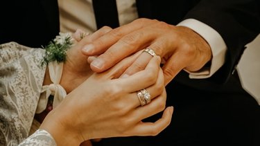 Married man and woman exchanging rings