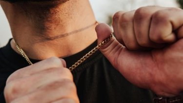 Man wearing gold chain necklace