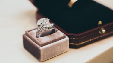 Silver ring on a grey ring case