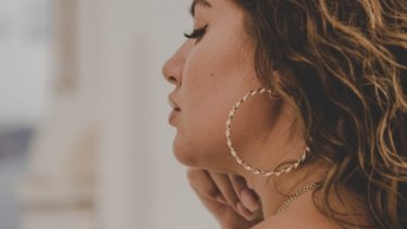 Woman wearing gold hoop earrings