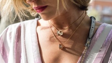 Woman wearing diamond ring and holding a book