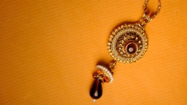 gold necklace with gemstones