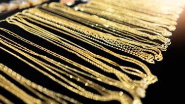 Gold necklaces displayed on black cloth