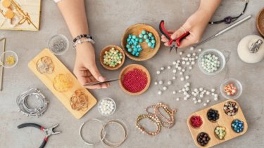 jewellery artist using different gemtstones on creation