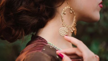 Woman wearing big gold earrings
