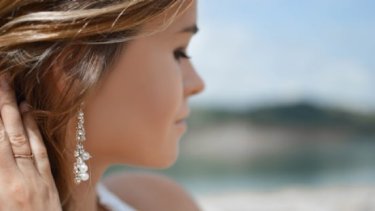 Woman on the beach wearing pearl earrings
