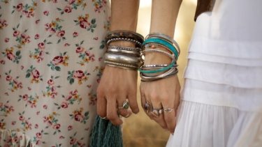 Women wearing chunky wrist cuffs